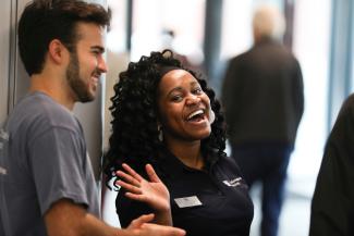 A student and orientation leader laughing.