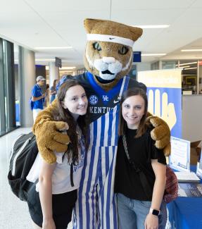 Two students with Wildcat at Orientation