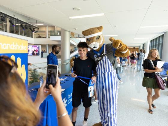 student with wildcat at orientation