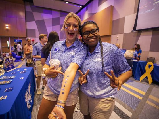 Two students at orientation resource fair 